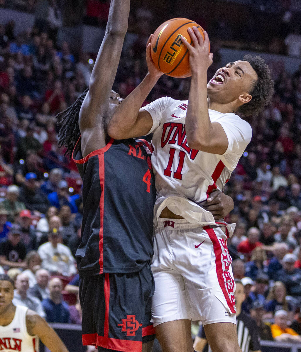 UNLV Rebels guard Dedan Thomas Jr. (11) is fouled as he attempts to shoot against San Diego Sta ...