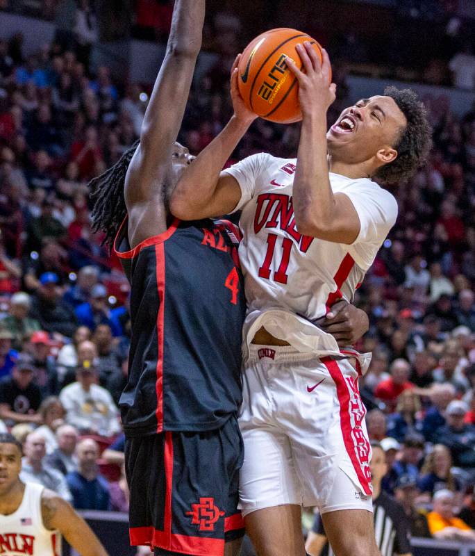 UNLV Rebels guard Dedan Thomas Jr. (11) is fouled as he attempts to shoot against San Diego Sta ...