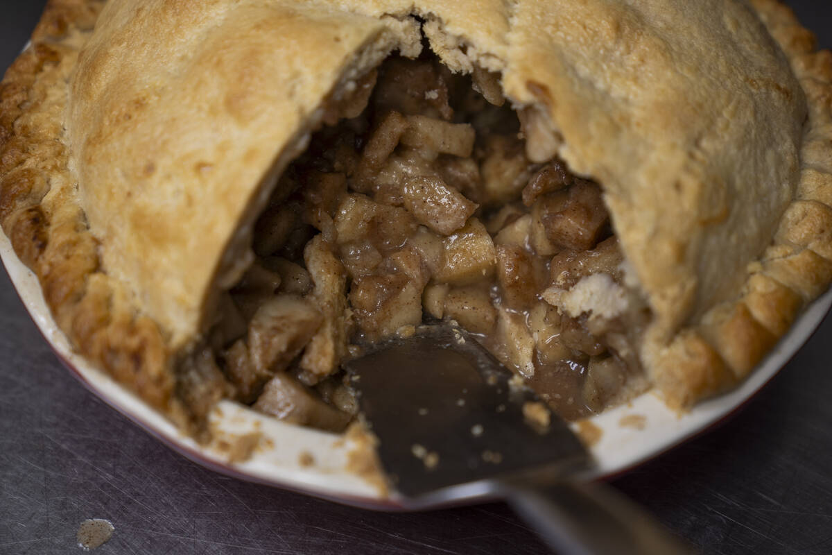 A country apple pie is sliced at Michele's Pies, Wednesday, March 13, 2024, in Norwalk, Conn. M ...