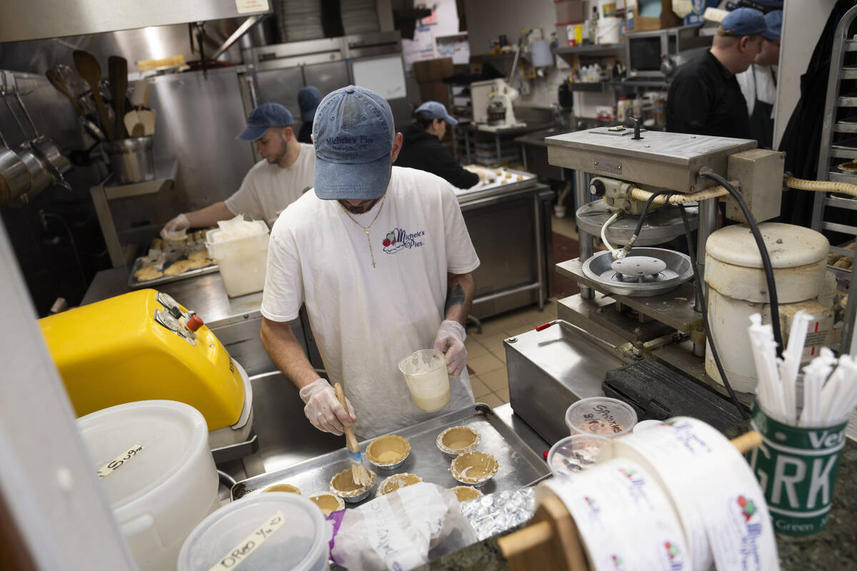 Employees work a busy bakery kitchen at Michele's Pies, Wednesday, March 13, 2024, in Norwalk, ...