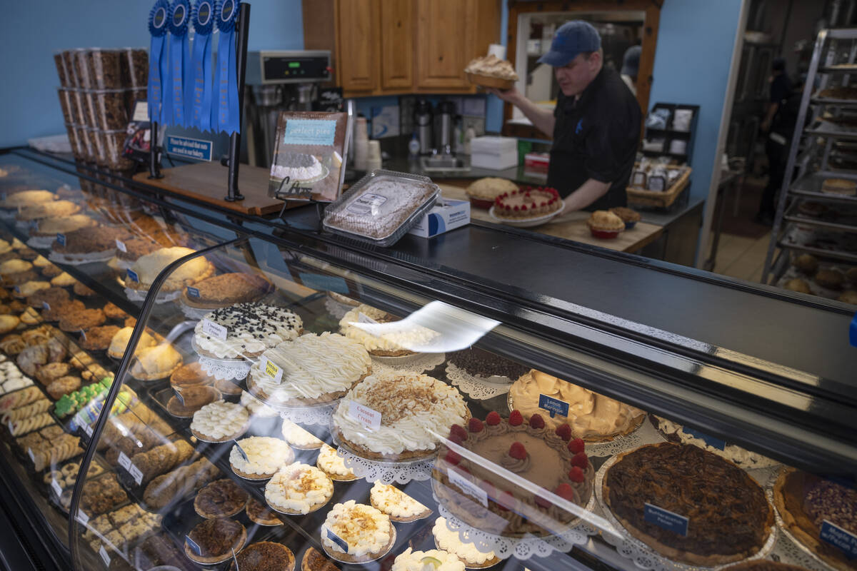 Manager Stephen Jarrett prepares pies on a counter at Michele's Pies, Wednesday, March 13, 2024 ...