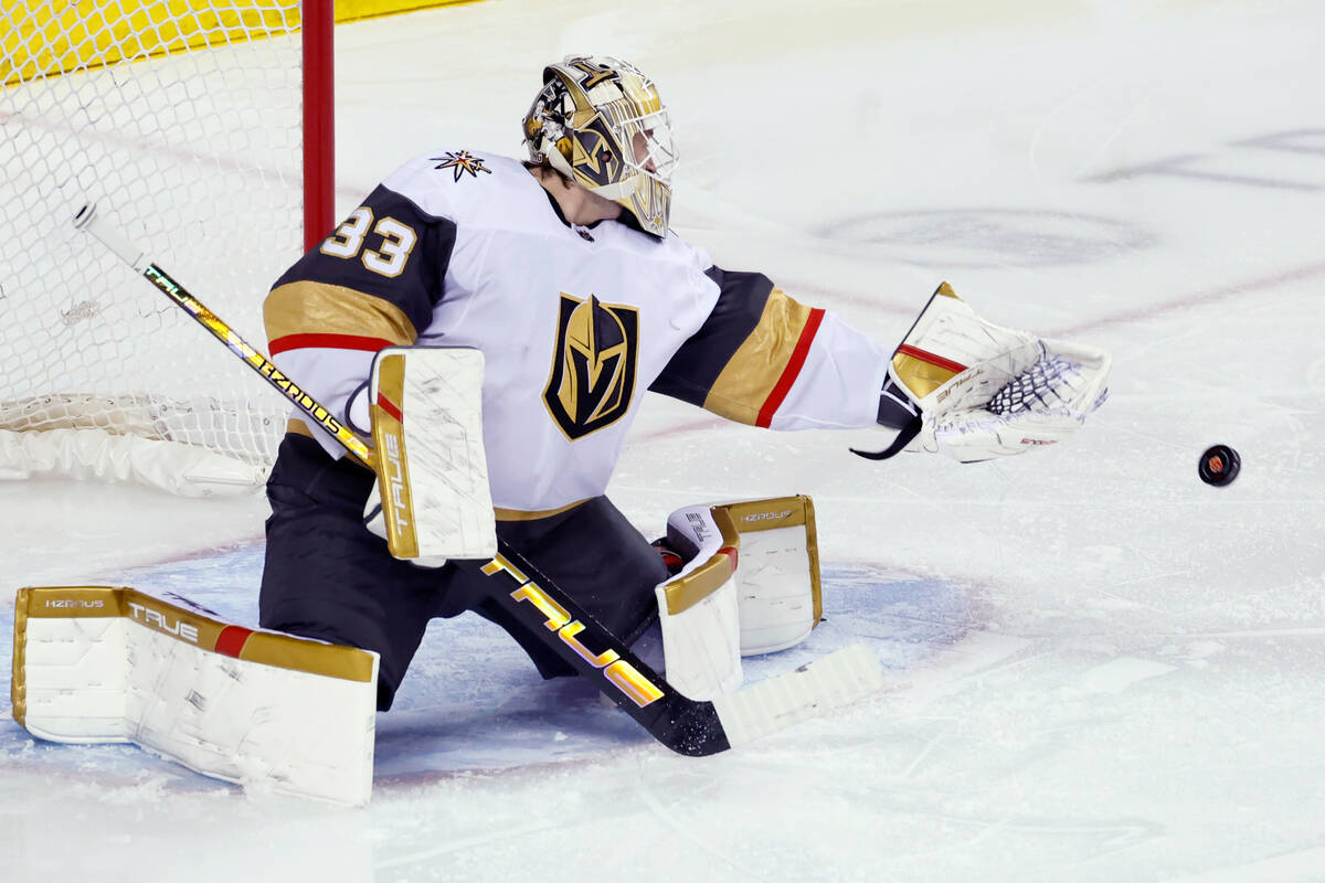 Vegas Golden Knights goalie Adin Hill makes a save on a Calgary Flames shot during the first pe ...