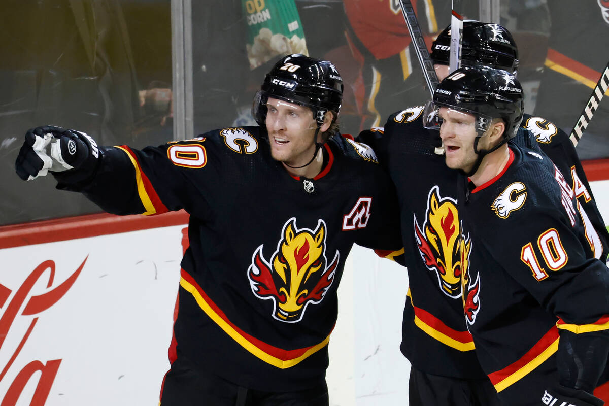 Calgary Flames' Blake Coleman, left, celebrates his goal against the Vegas Golden Knights with ...