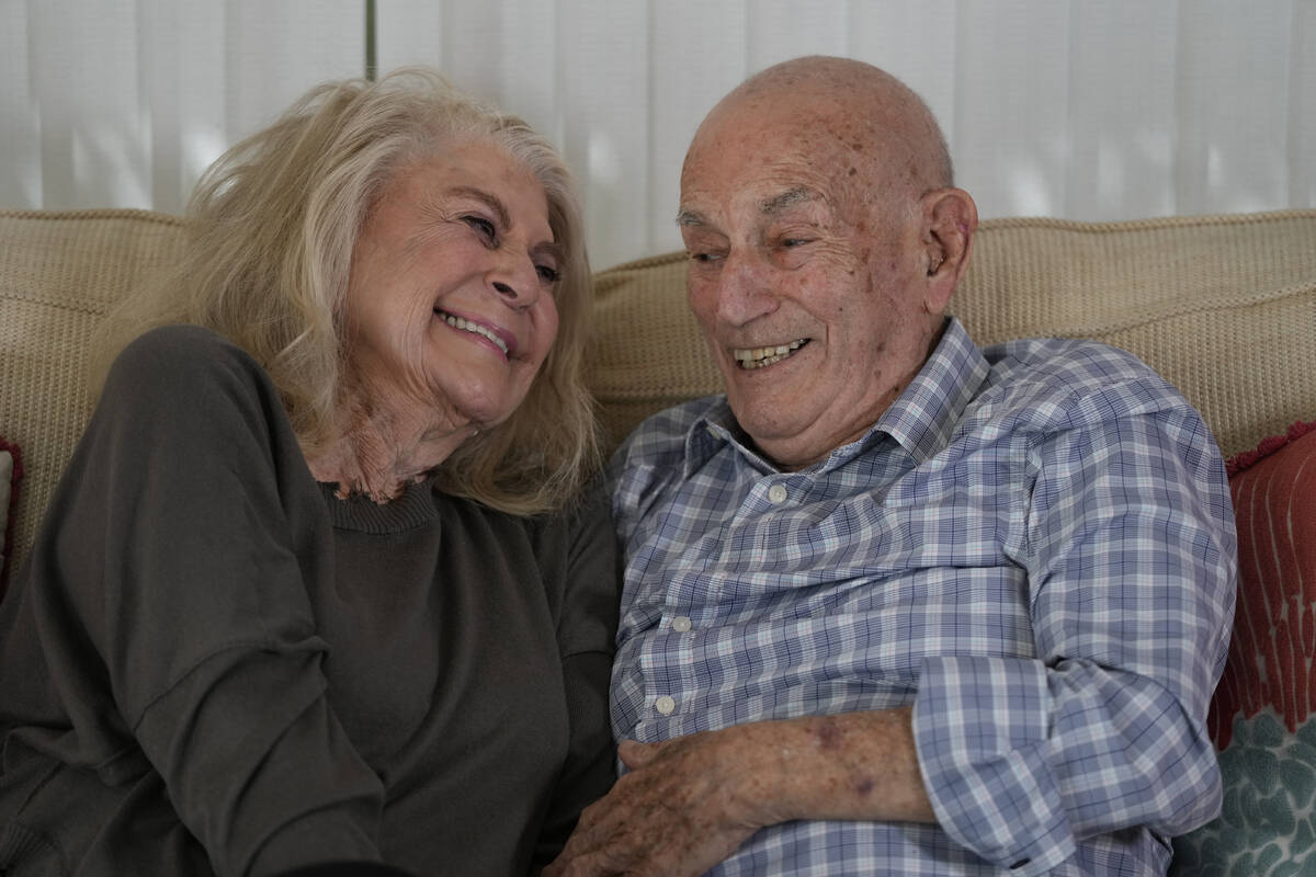 World War II veteran Harold Terens, 100, right, and Jeanne Swerlin, 96, share a laugh as they s ...