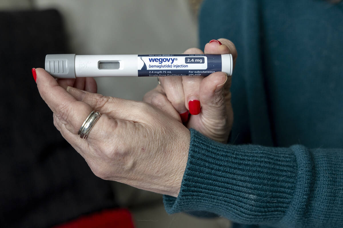 Donna Cooper holds up a dosage of Wegovy, a drug used for weight loss, at her home in Front Roy ...