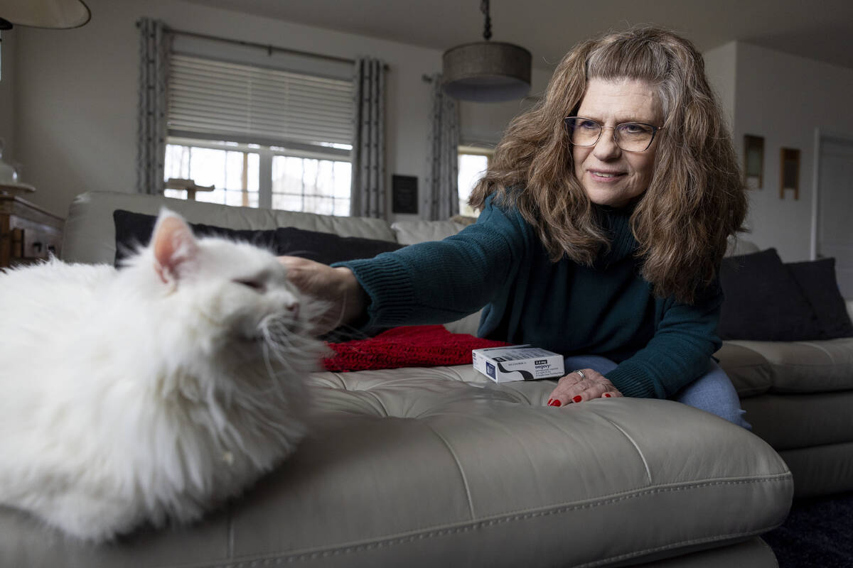 Donna Cooper pets her cat Cade at her home in Front Royal, Va., on Friday, March 1, 2024. Coope ...