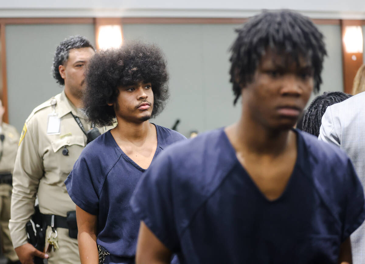 Treavion Randolph, 16, left, and Dontral Beaver, 16, right, enter the courtroom for a hearing a ...