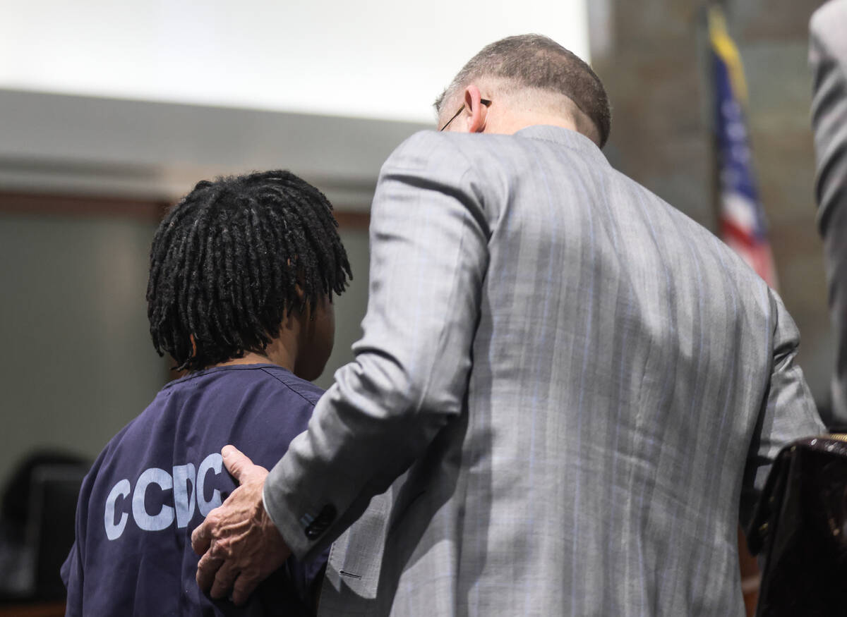 Defense attorney Robert Draskovich speaks with his client Gianni Robinson, 17, following a hear ...