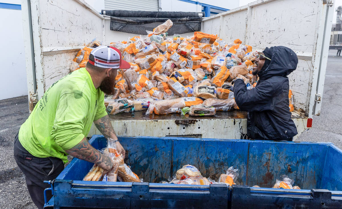 Chris Arnold, left, and Ken Fick with Logistical Solutions remove hundreds of bags of bread dum ...