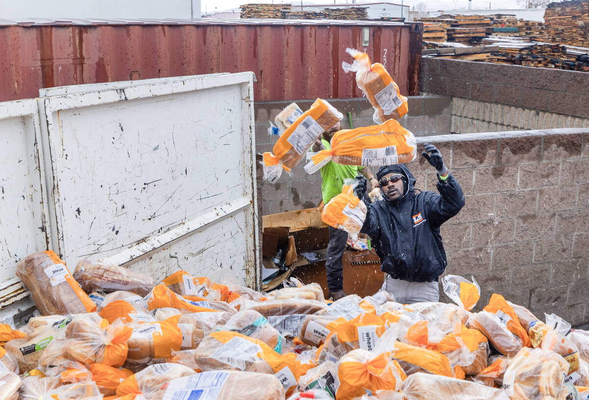 Ken Fick, near, and Chris Arnold with Logistical Solutions remove hundreds of bags of bread dum ...