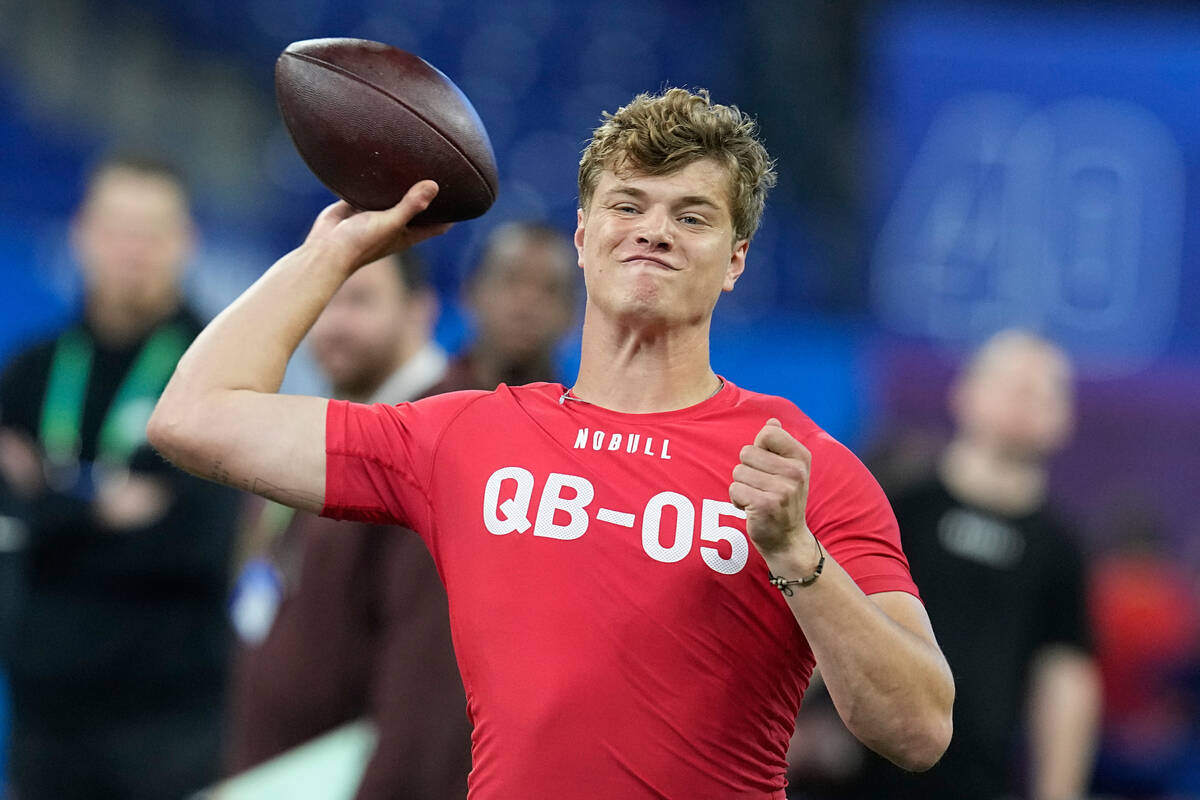 Michigan quarterback J.J. McCarthy runs a drill at the NFL football scouting combine, Saturday, ...