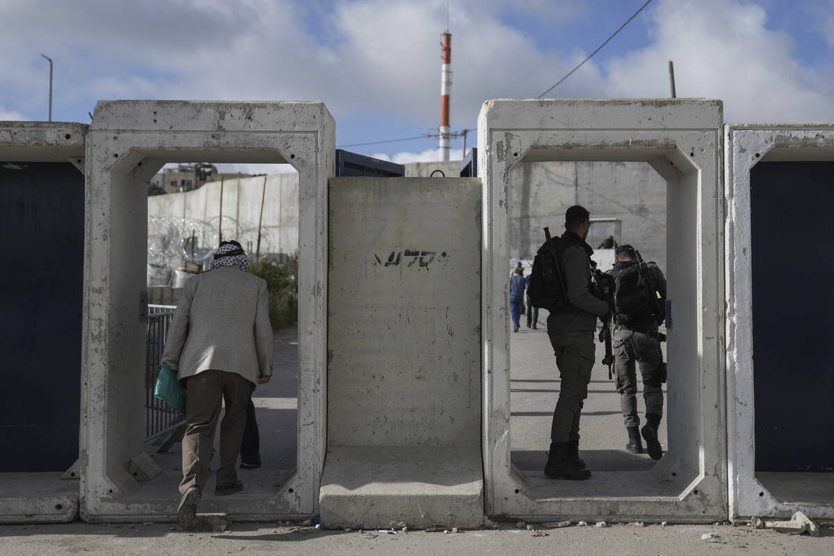 Palestinians cross from the Israeli military Qalandia checkpoint near the West Bank city of Ram ...