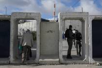 Palestinians cross from the Israeli military Qalandia checkpoint near the West Bank city of Ram ...
