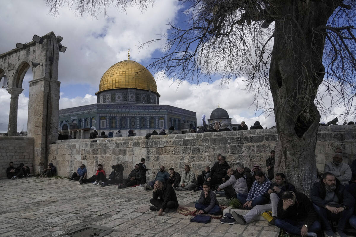 Muslim worshippers gather for Friday prayers by the Dome of Rock at the Al-Aqsa Mosque compound ...