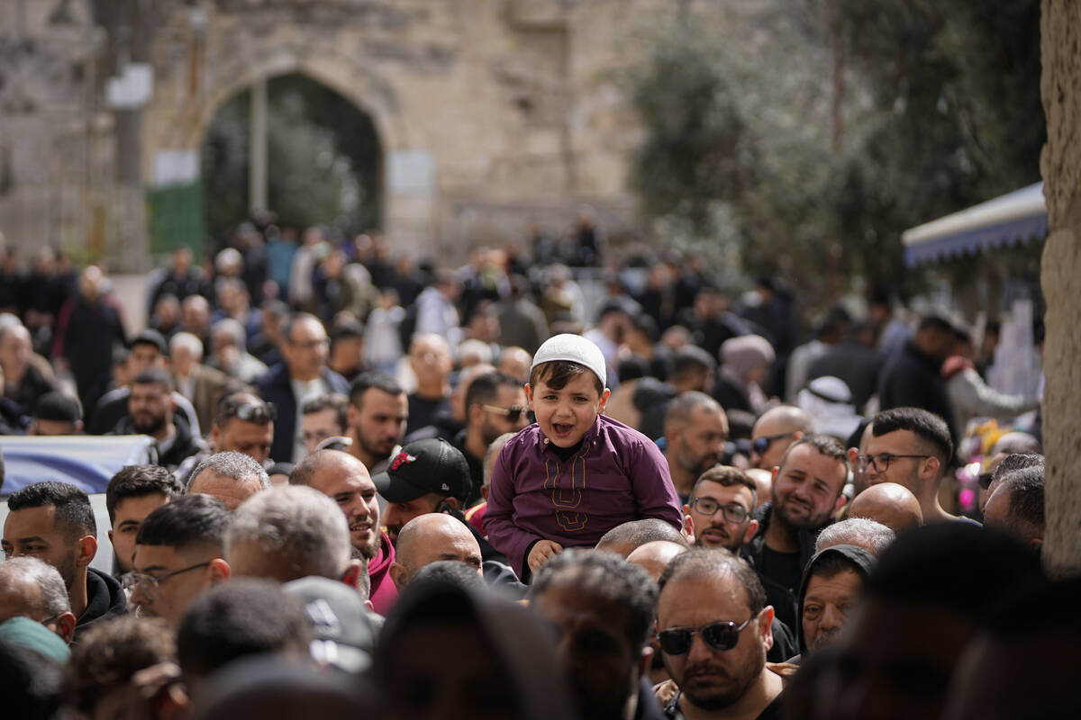 Muslim worshippers leave the Al-Aqsa Mosque compound after Friday prayers during the Muslim hol ...
