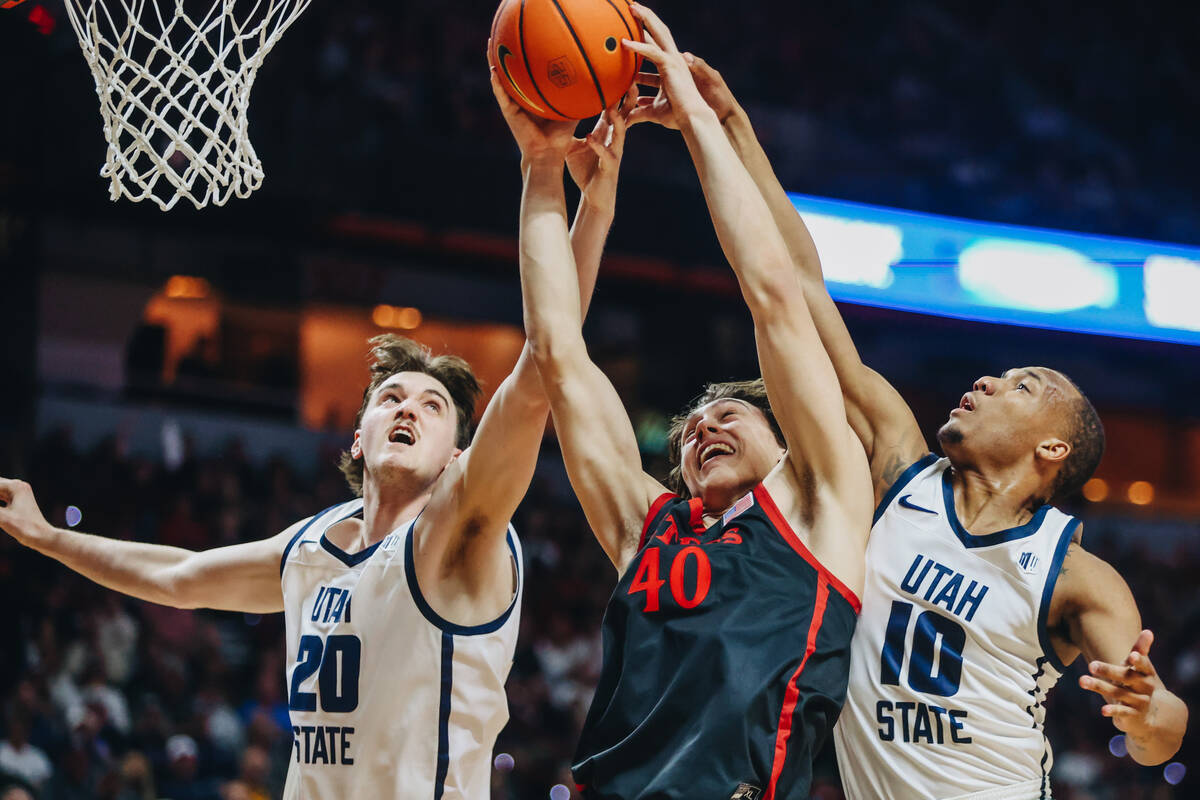 San Diego State Aztecs forward Miles Heide (40) battles it out with Utah State center Isaac Joh ...