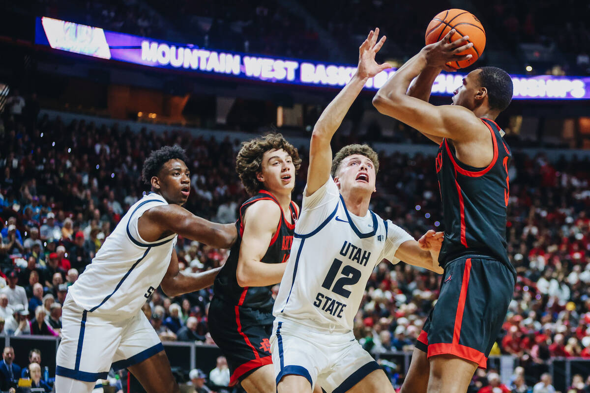 San Diego State Aztecs guard Micah Parrish (3) eyes the hoop for a basket as Utah State guard M ...