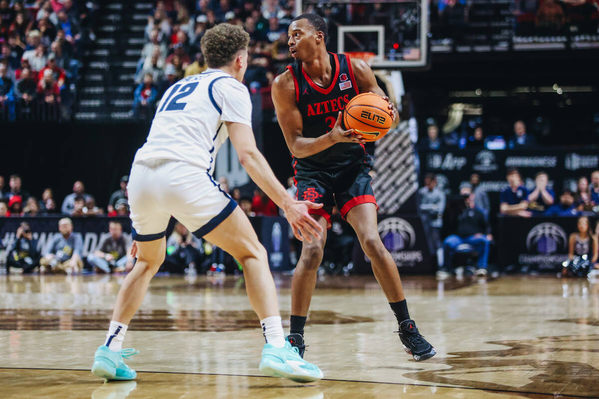 San Diego State guard Micah Parrish (3) eyes a teammate as he keeps the ball from Utah State gu ...