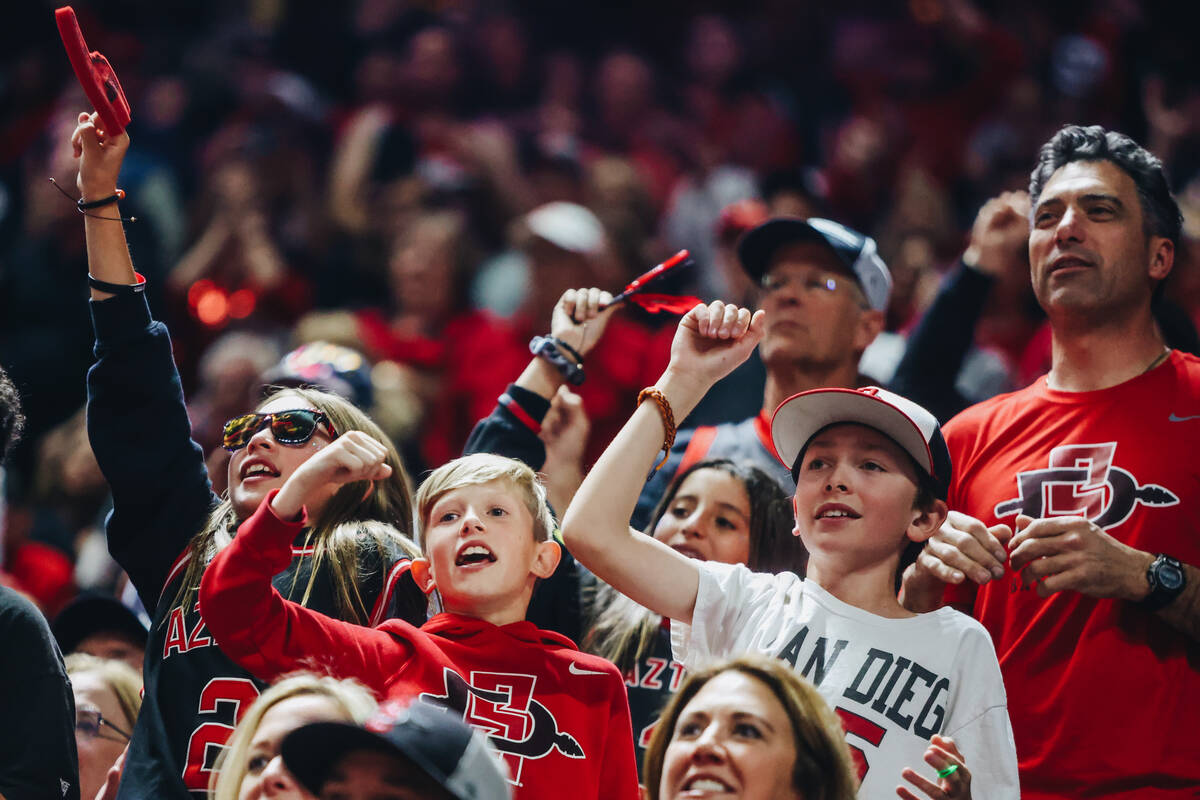 San Diego State fans cheer during a game against Utah State during the Mountain West tournament ...