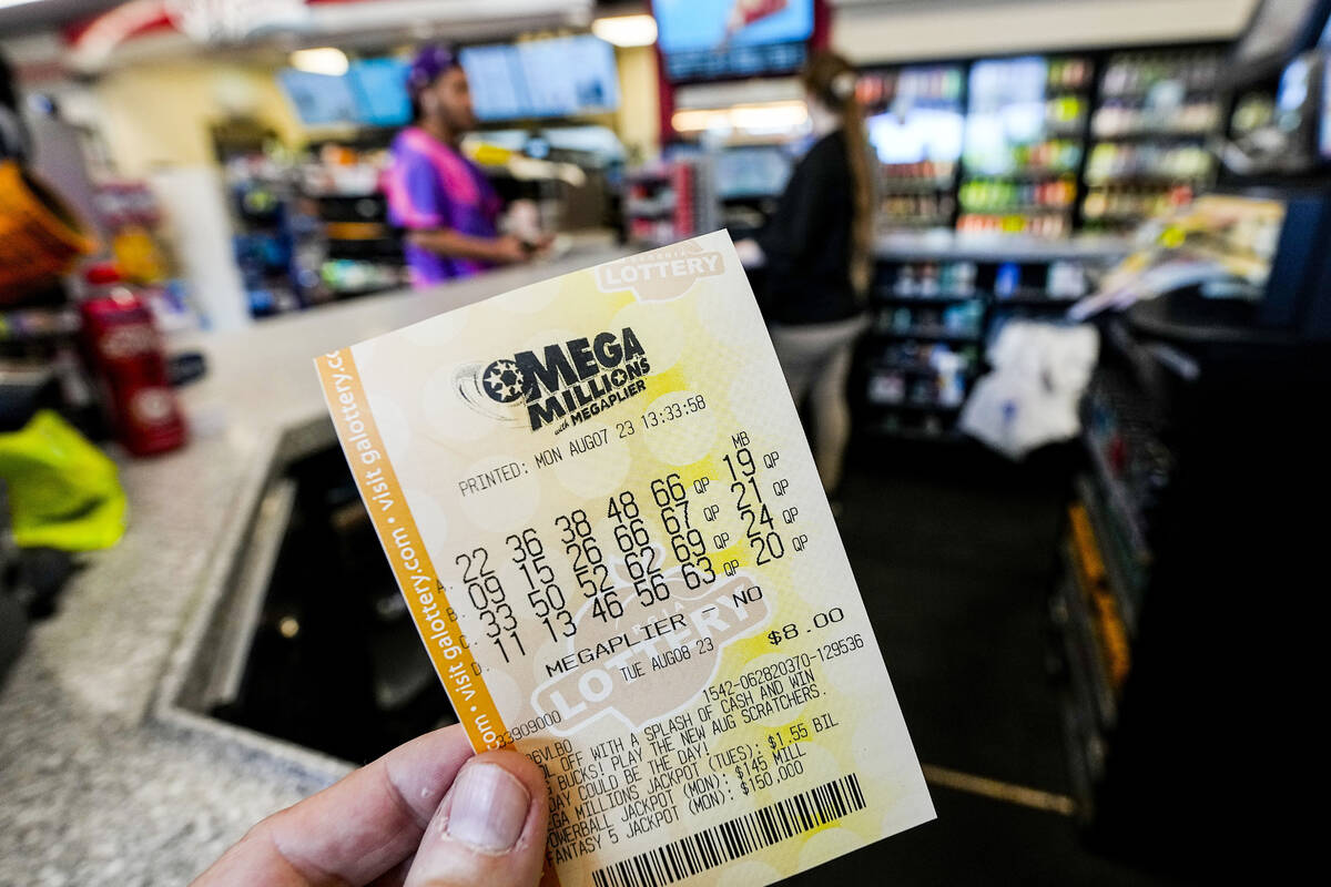 A Mega Millions ticket is seen as a person makes a purchase inside a convenience store on Monda ...