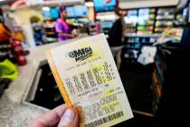 A Mega Millions ticket is seen as a person makes a purchase inside a convenience store on Monda ...