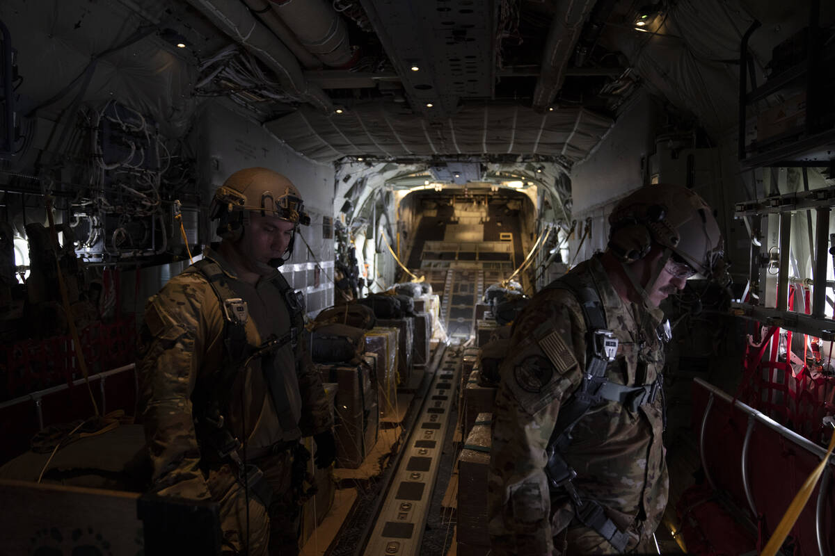 AP reporters aboard a U.S. military plane watch small batches of aid airdropped on Gaza
