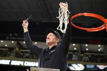Long Beach State head coach Dan Monson participates in a net cutting ceremony after his team pl ...