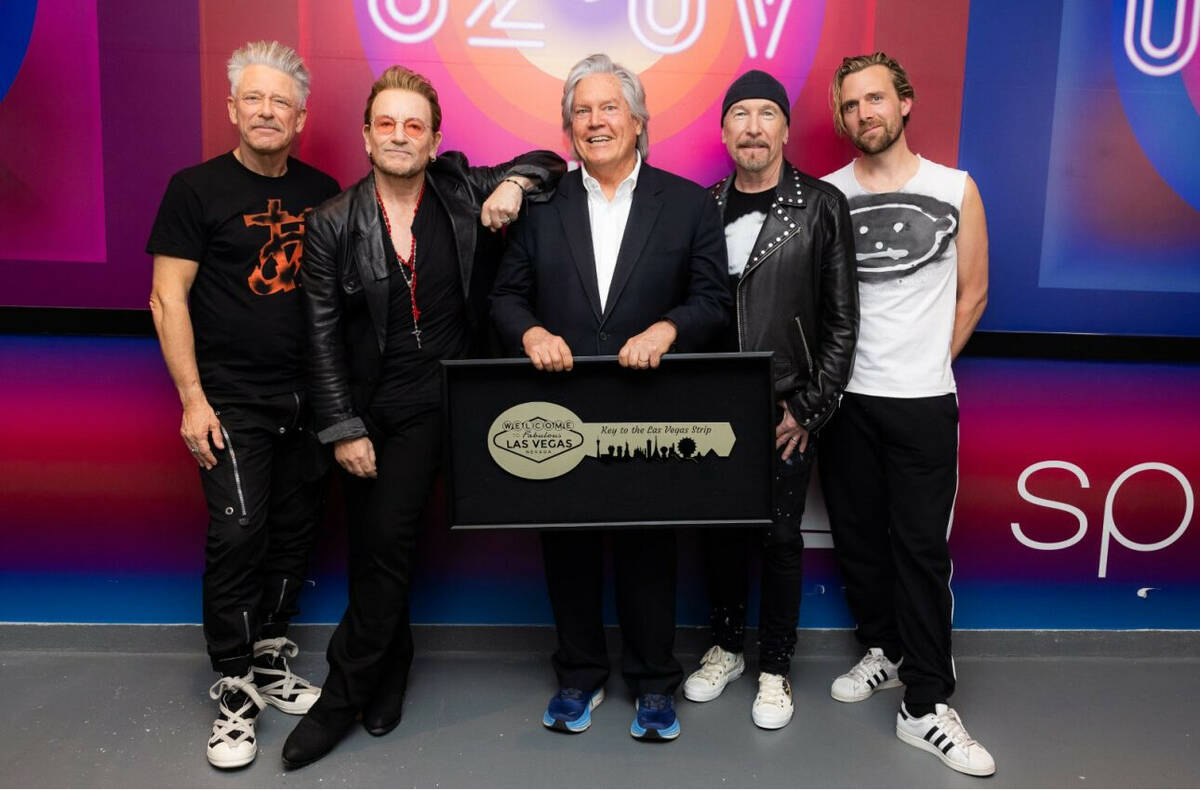 Clark County Commissioner Tick Segerblom, middle, is shown with U2 as he presents the band with ...