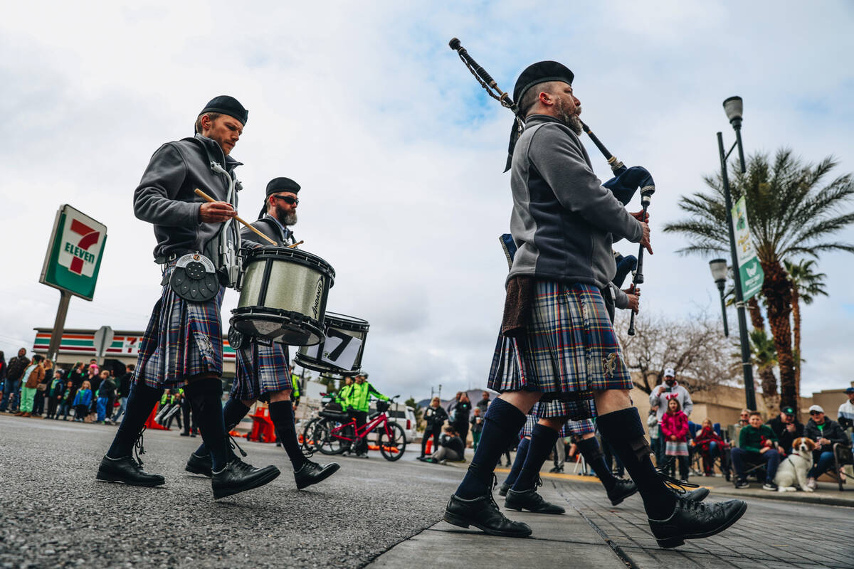 A pipe band makes its way down Water Street during the St. Patrick’s Day parade on Satur ...