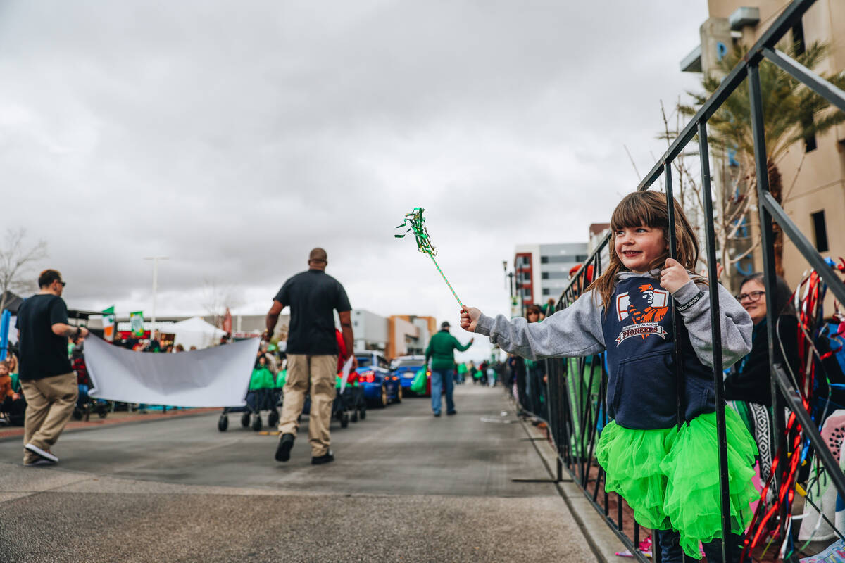 A child cheers as parade festivities make their way down the road during the St. Patrick&#x2019 ...