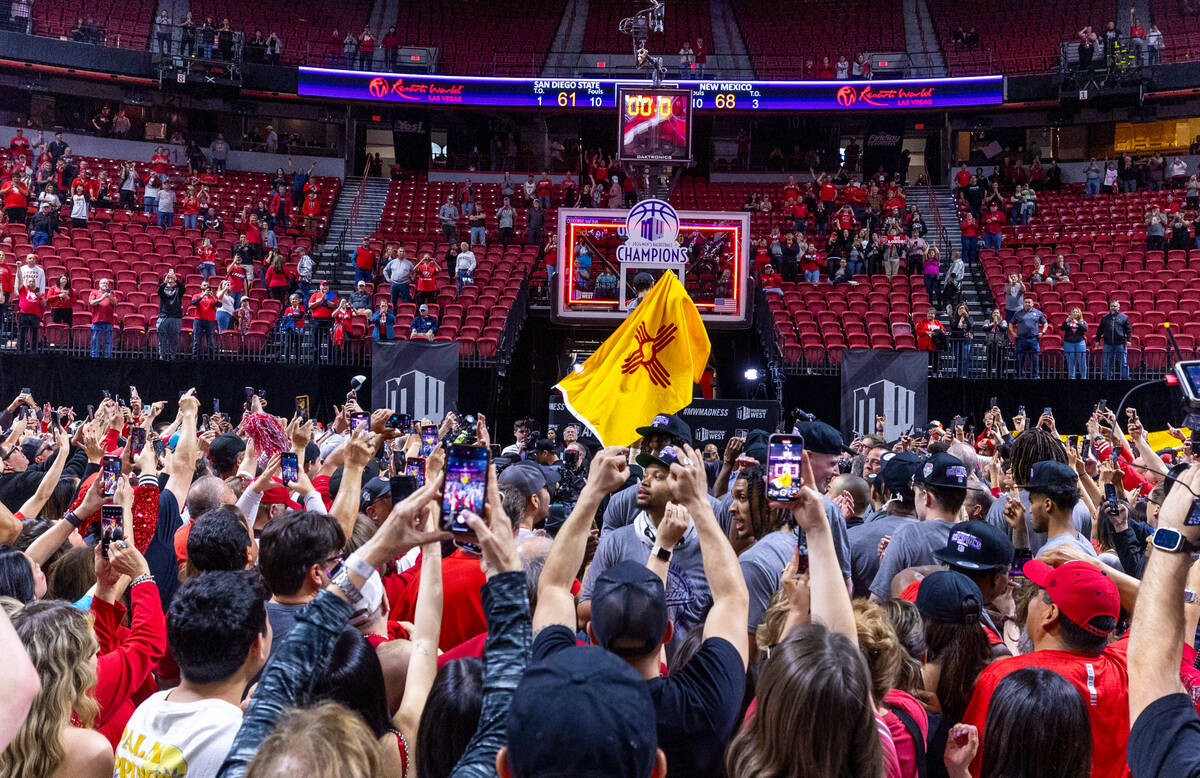 New Mexico Lobos guard Jaelen House (10) is draped in a New Mexico flag as he cuts the net befo ...