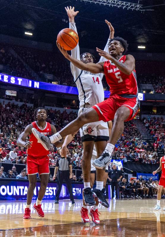 New Mexico Lobos guard Jamal Mashburn Jr. (5) yells ias he leaps past San Diego State Aztecs gu ...