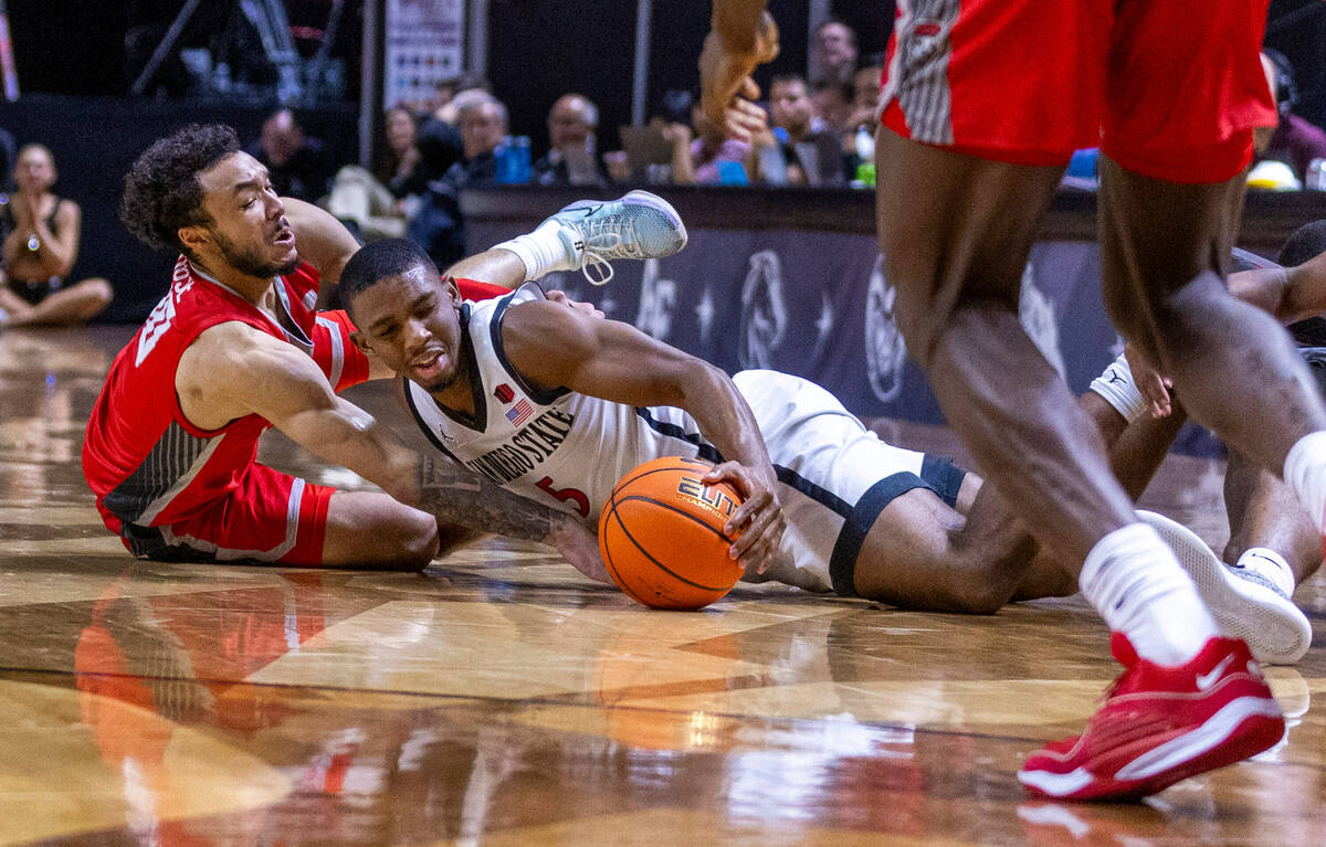 New Mexico Lobos guard Jaelen House (10) and San Diego State Aztecs guard Lamont Butler (5) cha ...