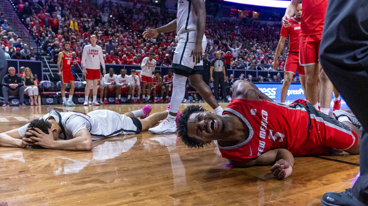 New Mexico Lobos guard Jamal Mashburn Jr. (5) yells in pain as he and San Diego State Aztecs gu ...