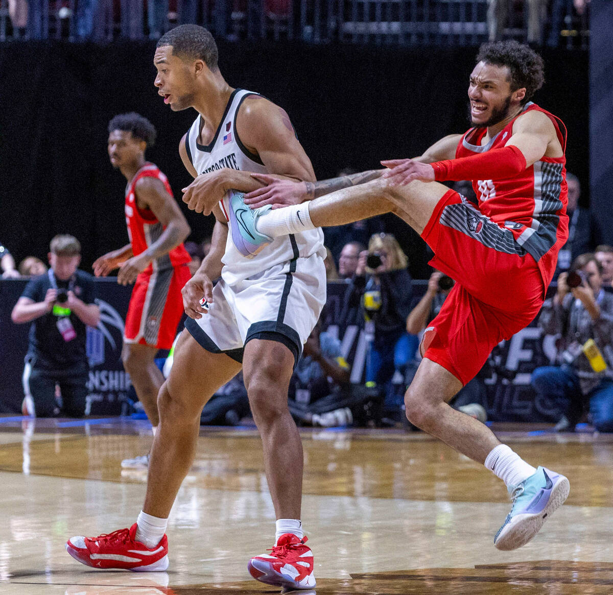 San Diego State Aztecs forward Jaedon LeDee (13) and New Mexico Lobos guard Jaelen House (10) g ...