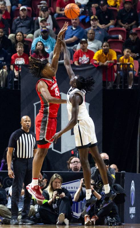 New Mexico Lobos forward JT Toppin (15) gets off a shot and is fouled by San Diego State Aztecs ...