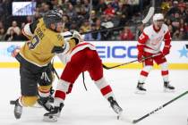 Golden Knights center Jack Eichel (9) falls while passing for an assist during the third period ...