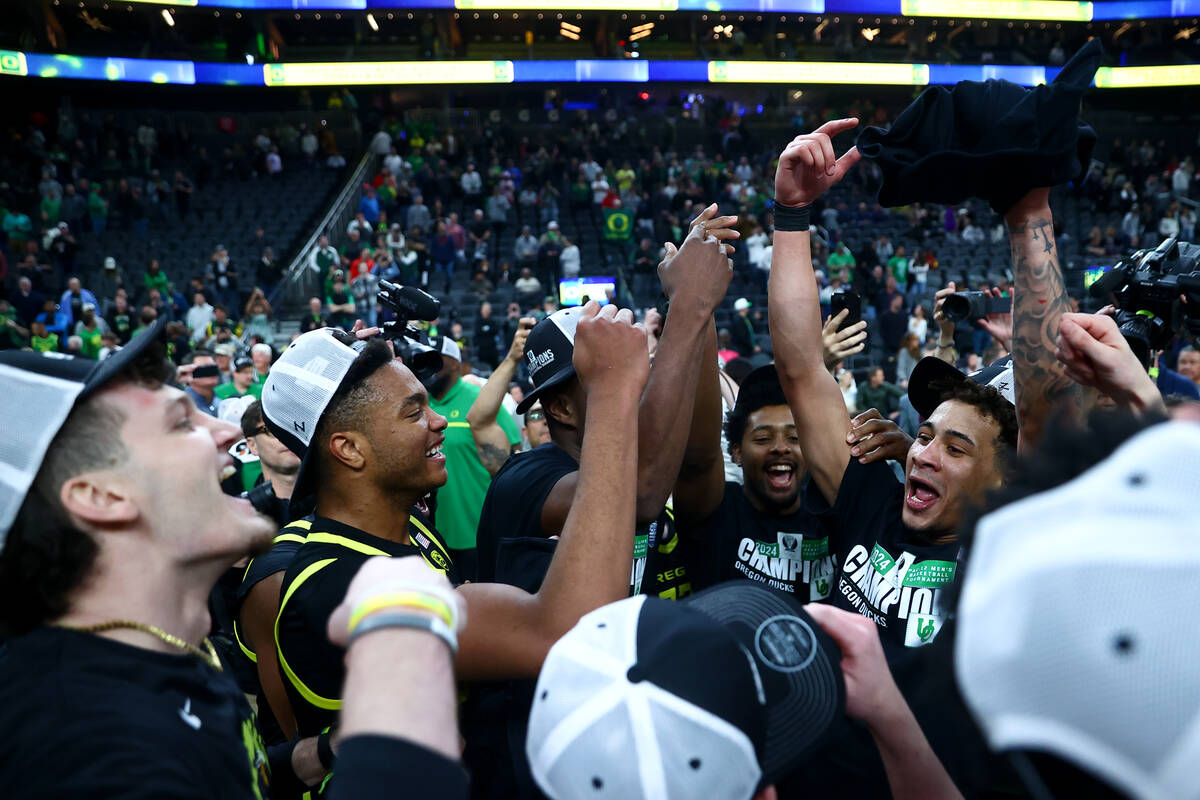The Oregon Ducks celebrate after winning the championship game in the men's Pac-12 Tournament a ...