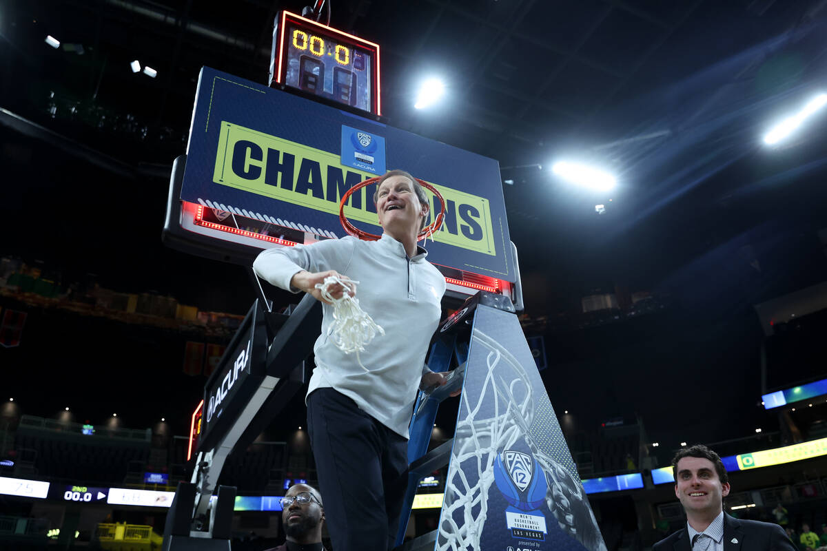 Oregon Ducks head coach Dana Altman throws a piece of net to his players after the Ducks beat t ...