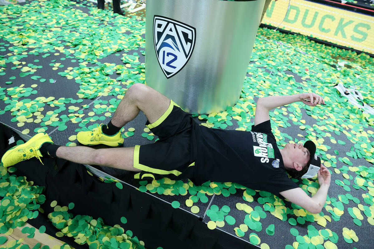 An Oregon player FaceTimes after winning the men's Pac-12 Tournament championship game against ...