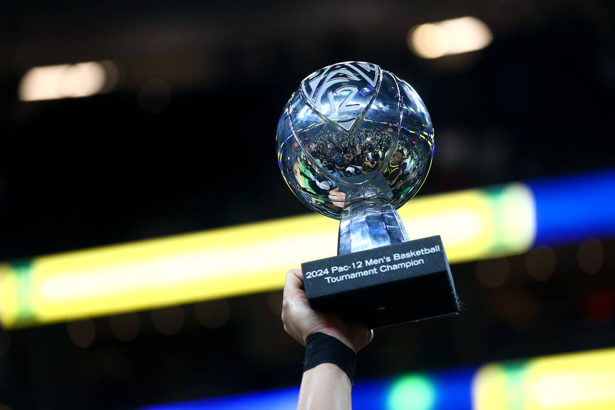 Oregon holds up its trophy after defeating the Colorado Buffaloes to win the championship game ...