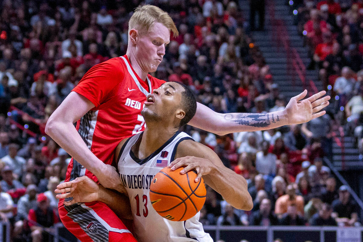 San Diego State Aztecs forward Jaedon LeDee (13) collides into New Mexico Lobos center Sebastia ...