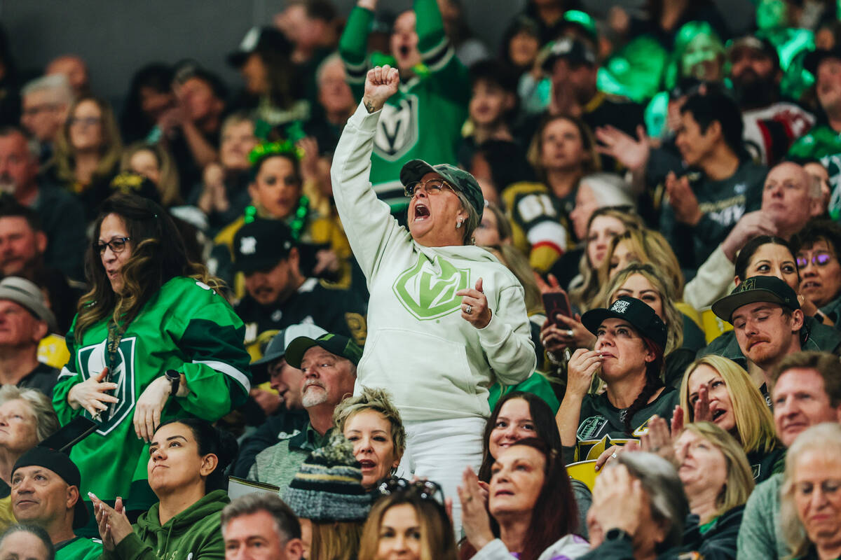 A Golden Knights fan cheers as it is announced that a potential goal made by the New Jersey Dev ...