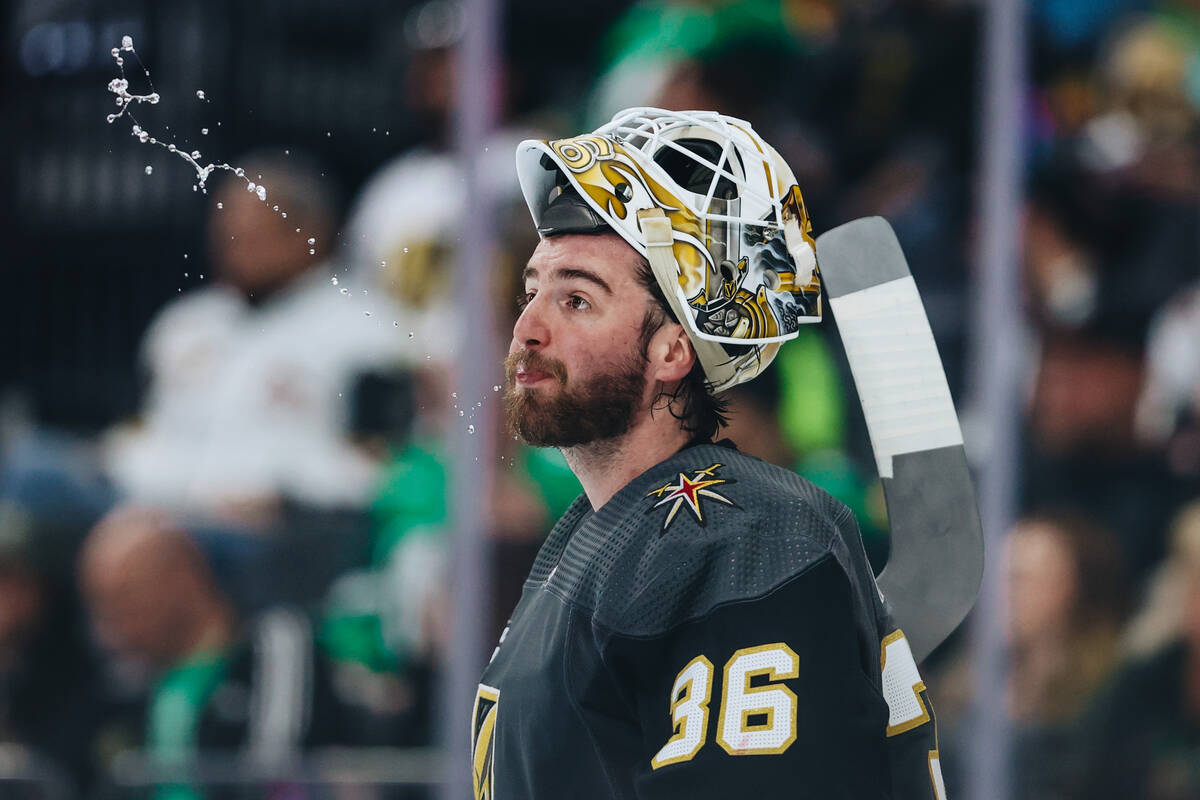 Golden Knights goaltender Logan Thompson (36) spits out his water during an NHL game between th ...