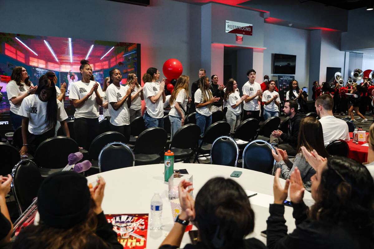 Members of the UNLV Lady Rebels basketball team applaud with the audience after their placement ...