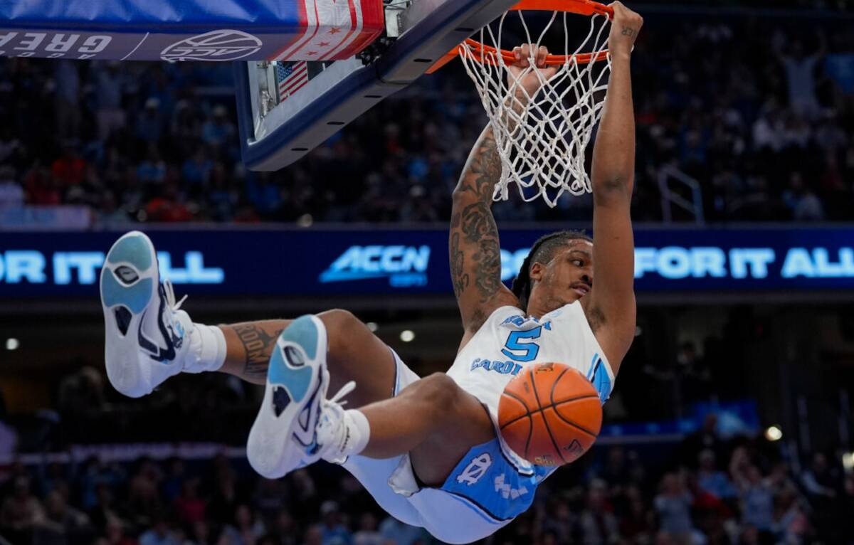 North Carolina forward Armando Bacot (5) hanging from the basket after scoring against Pittsbur ...