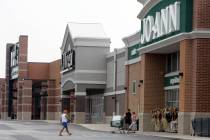 People walk into and out of a Joann store, Sept. 6, 2007, in Garfield Heights, Ohio. The fabric ...