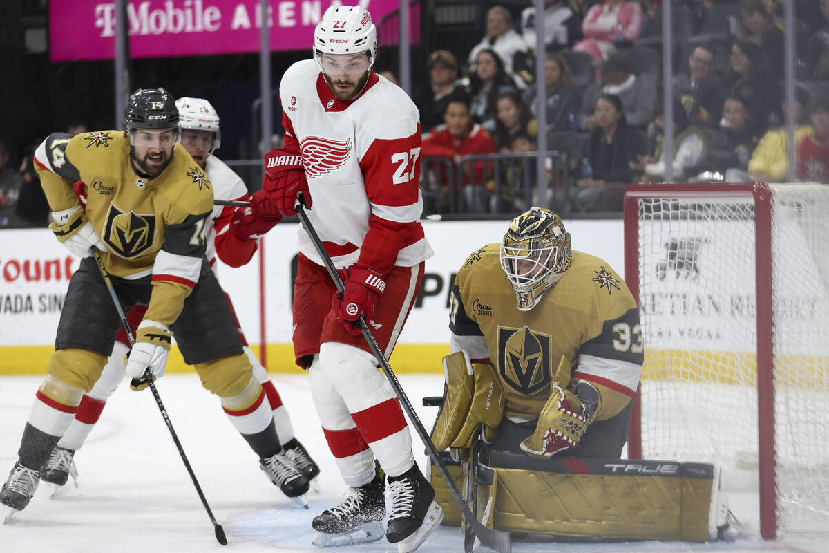 Golden Knights goaltender Adin Hill (33) saves the puck while Red Wings center Michael Rasmusse ...