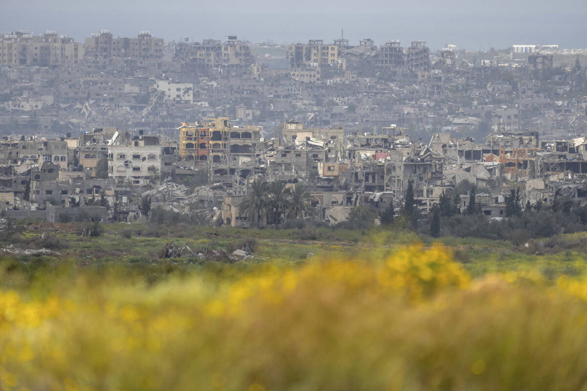 Destroyed buildings stand in the Gaza Strip as seen from southern Israel, Monday, March 18, 202 ...