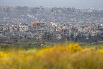 Destroyed buildings stand in the Gaza Strip as seen from southern Israel, Monday, March 18, 202 ...